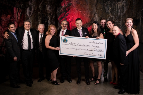 Members of Miners for Cancer alongside G-Rant from Newcap Radio’s Hot 93.5FM seen here holding a $20,000 cheque that will go towards renovating the chemotherapy suites at the Northeast Cancer Centre in Sudbury, Ontario.